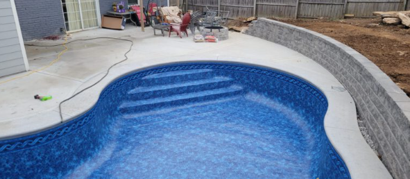 Curved custom inground pool with premium finish in Middle Tennessee backyard