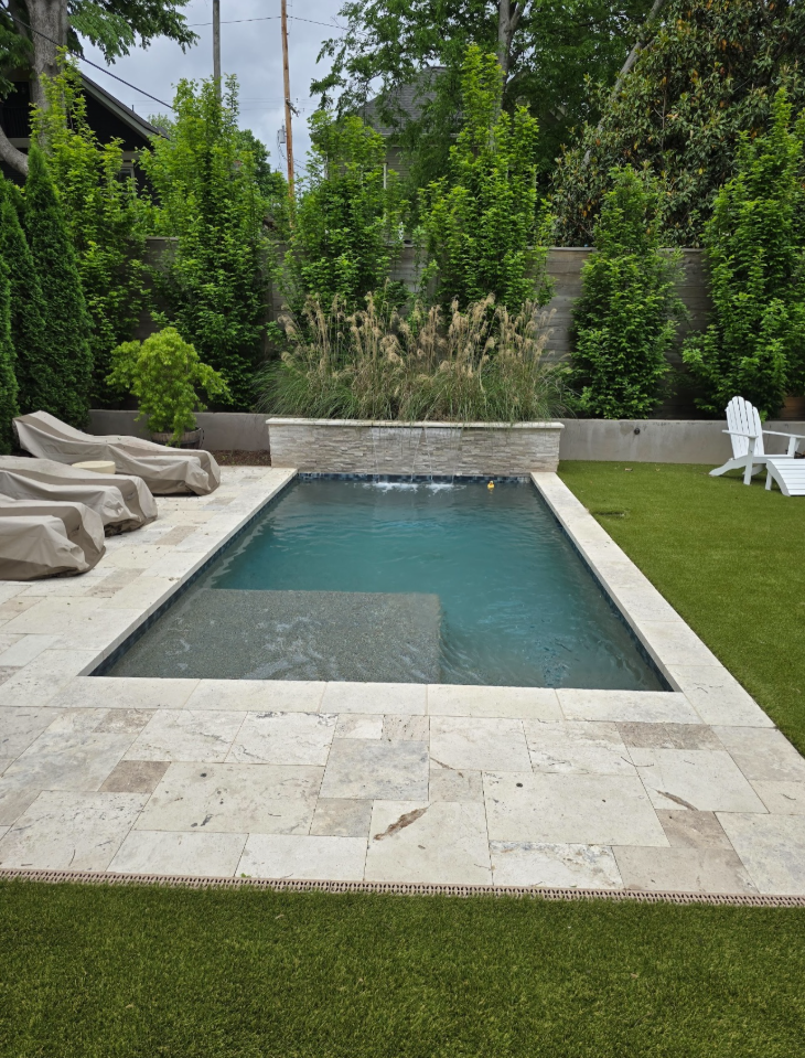 Custom gunite pool with stone water features built by Pool Fever in Middle Tennessee